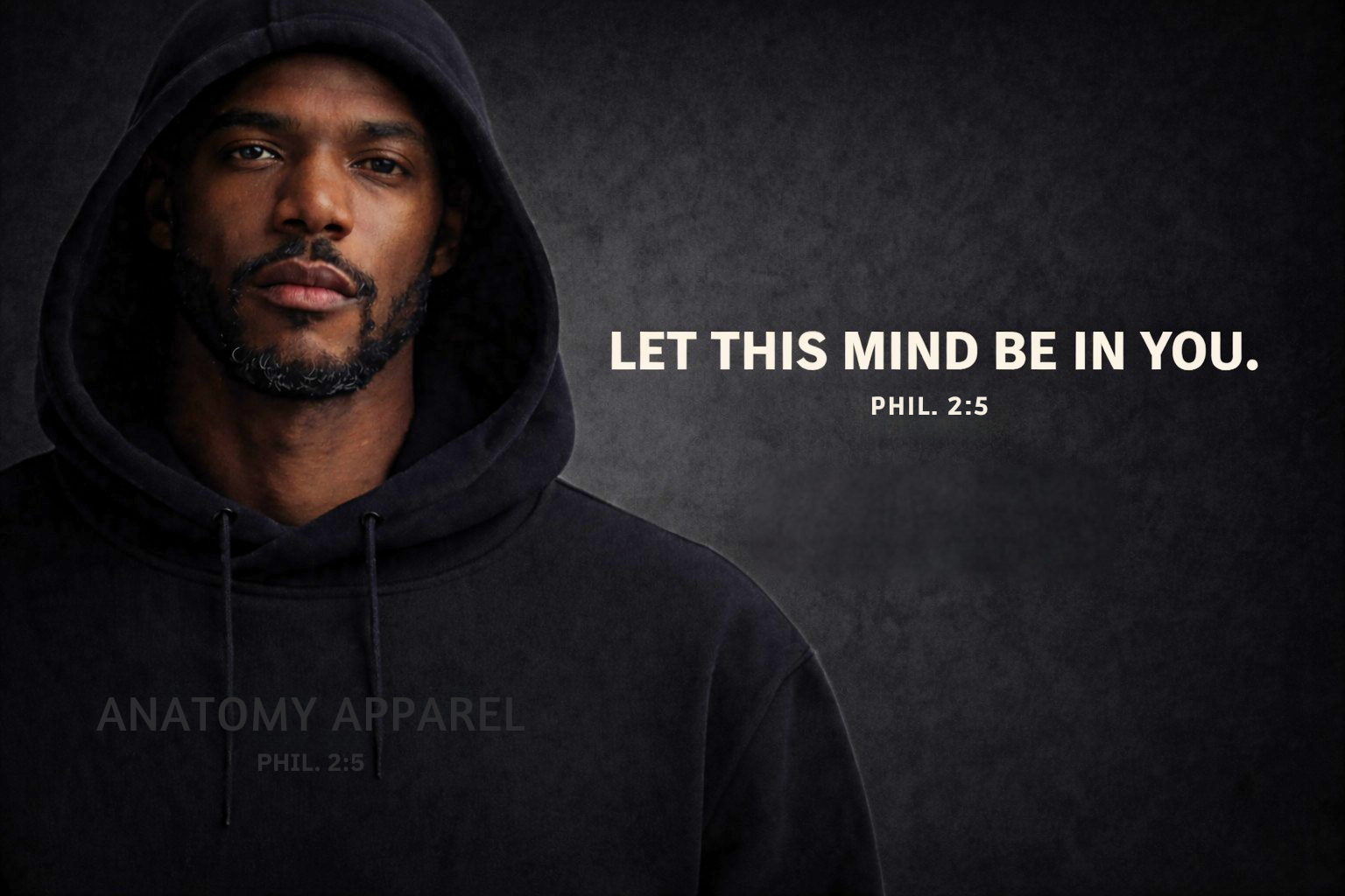 Man wearing a black hoodie with a motivational quote on a dark background