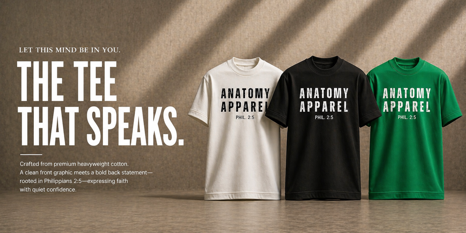 Three t-shirts in white, black, and green with 'Anatomy Apparel' branding on a wooden surface.